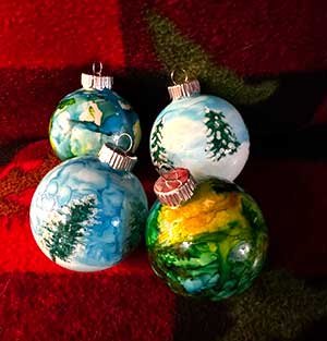 a photo showing 4 alcohol ink Christmas Balls
