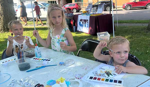 photo of two children doing art project at farmers market, Pulaski, NY