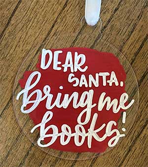 a hand lettered ornament with the message "merry and bright"