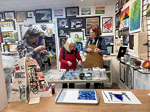 a photo of the instructor teaching a glass in glass fusing
