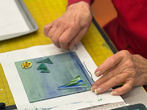 a photo of the instructor teaching a glass in glass fusing