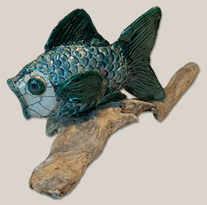 a raku fish mounted on driftwood made by Billie Jo Peterson