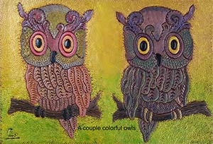 leather work panel showing two colorful owls
