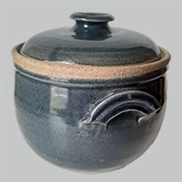 a piece of pottery with a lid and handles