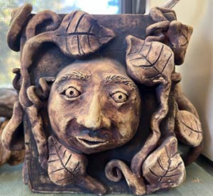 example of a face in a vase clay sculpture