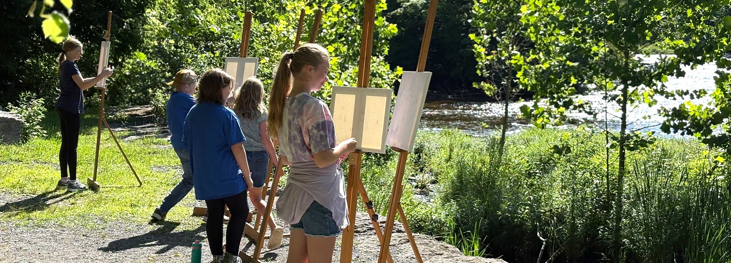 young artists from our YAE Summer Arts Camp program painting en plain air at the Salmon River, Pulaski