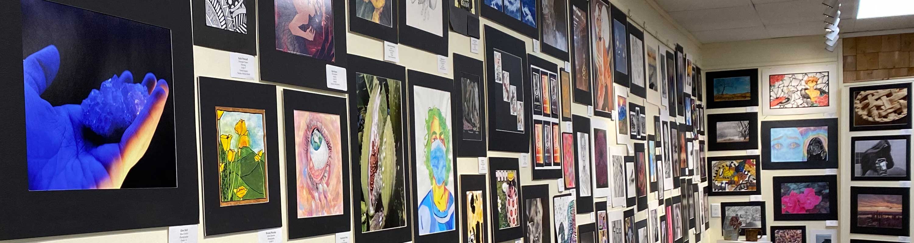 wall of artwork from The Student Art Show 2022