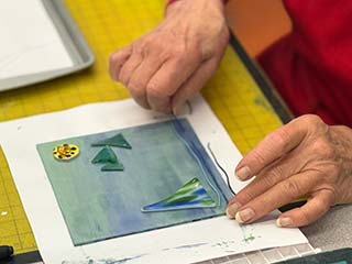 a photo of someone doing glass fusing