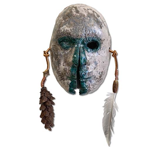 ceramic mask with feather and pinecone